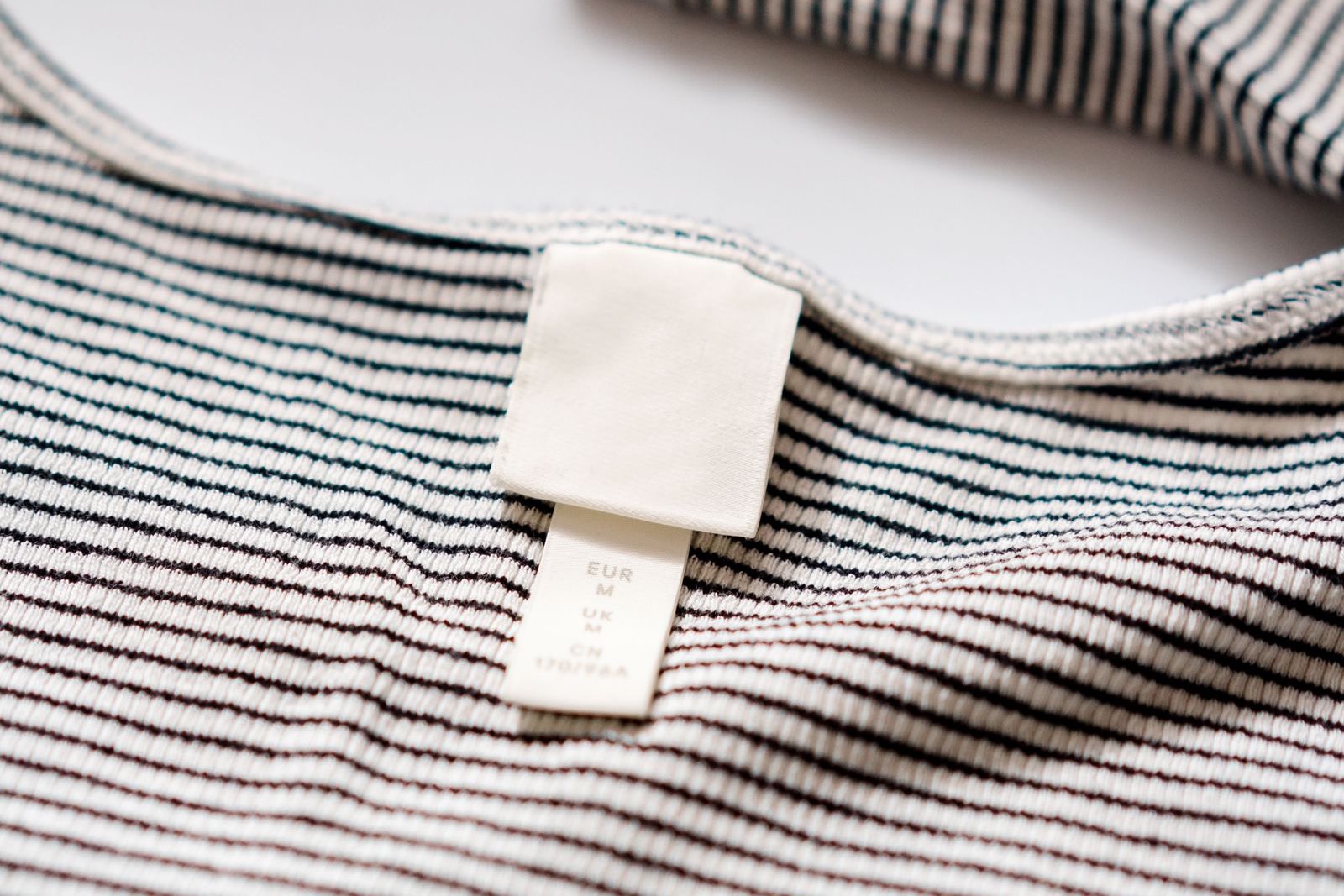 Woven brand label stitched onto a garment
